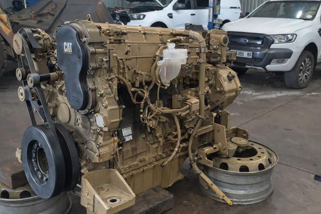 A large Caterpillar diesel engine on a workshop stand awaiting strip-down