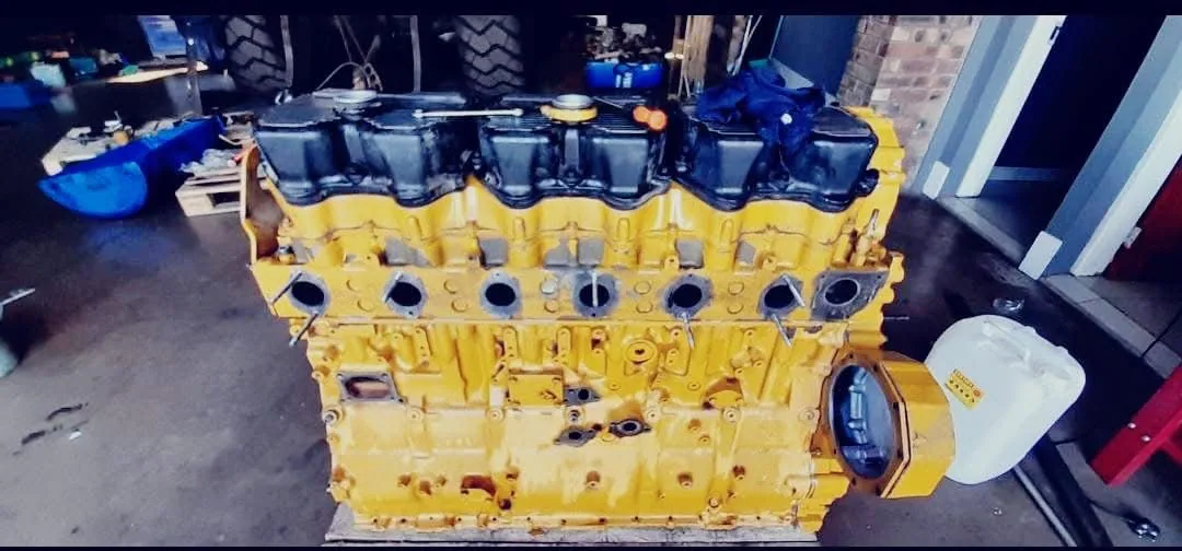 A six-cylinder engine block stripped, cleaned and laid out for measurement