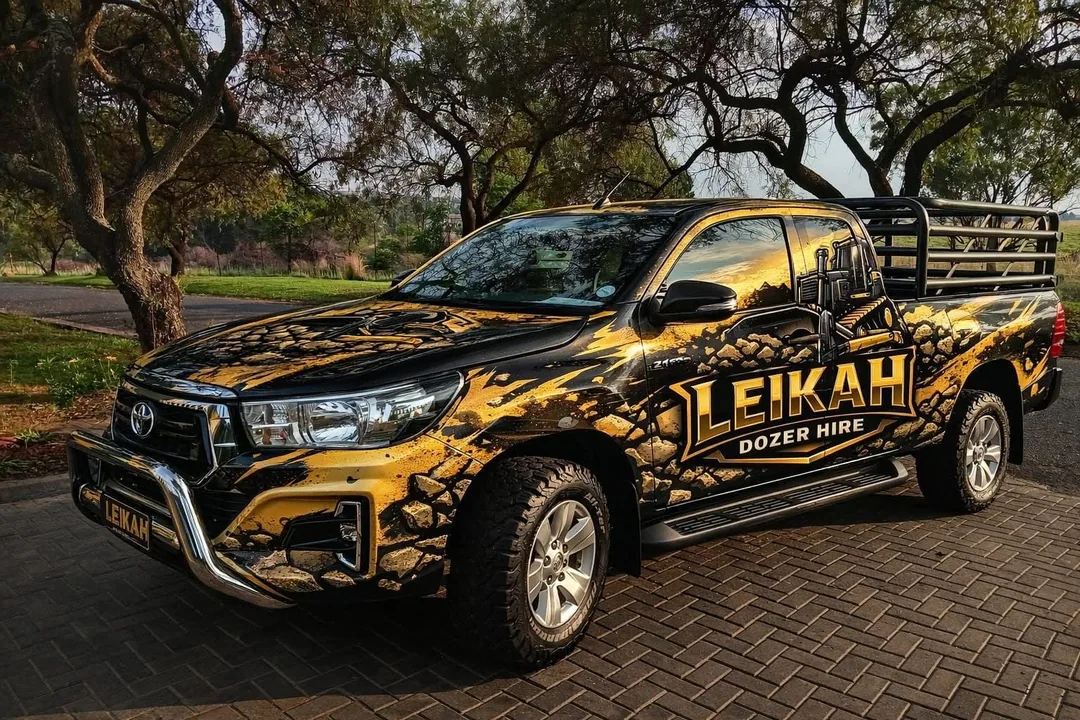 A Leikah-liveried Toyota Hilux service bakkie in gold and black branding